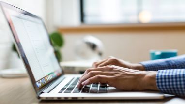 Person die auf einem Laptop tippt